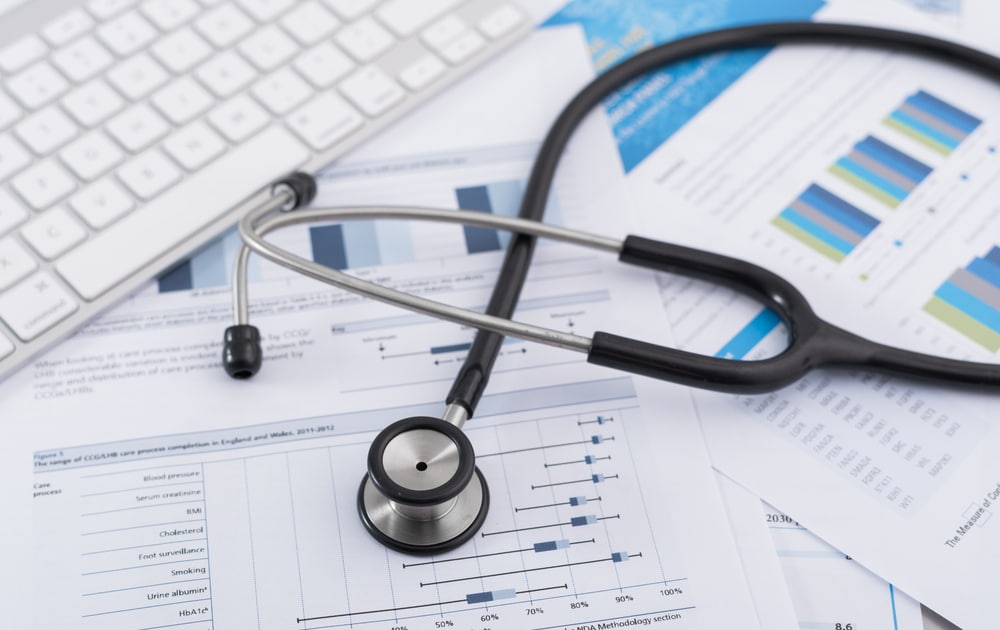 A stethoscope on a pile of documents