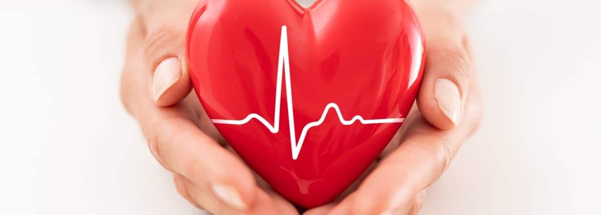 Woman holding red heart symbol