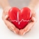 Woman holding red heart symbol