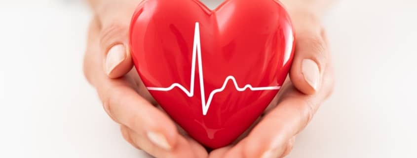 Woman holding red heart symbol