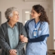 A nurse helping a senior patient walking