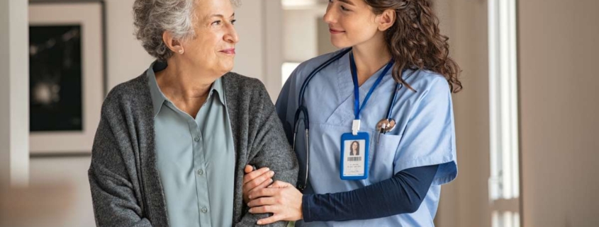 A nurse helping a senior patient walking