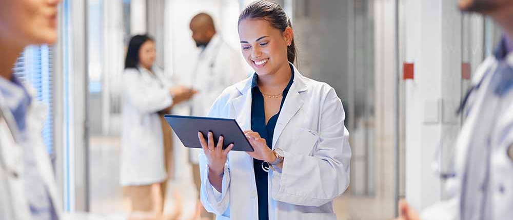 A member of a quality improvement team accesses data on a tablet while collaborating with the operations team