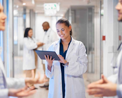 A member of a quality improvement team accesses data on a tablet while collaborating with the operations team