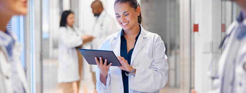 A member of a quality improvement team accesses data on a tablet while collaborating with the operations team