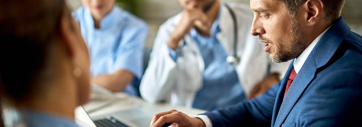 Doctors and administrators looking at data