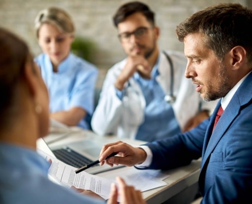 Doctors and administrators looking at data