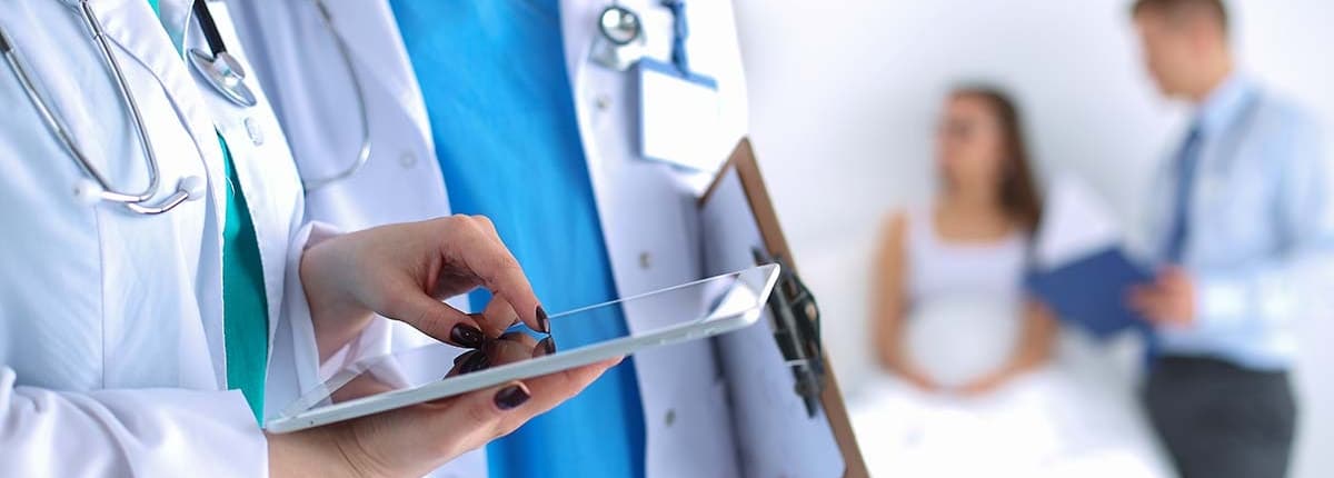 Two doctors looking at a tablet