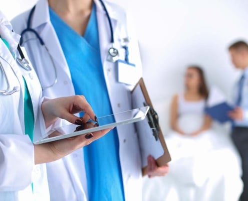 Two doctors looking at a tablet