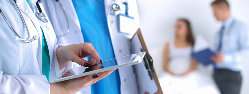 Two doctors looking at a tablet