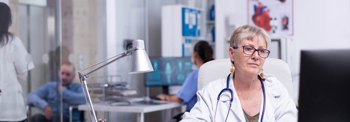 A frontline staff member enters patient safety data into a computer at a healthcare facility