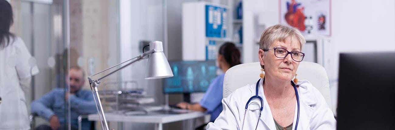 A frontline staff member enters patient safety data into a computer at a healthcare facility