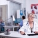 A frontline staff member enters patient safety data into a computer at a healthcare facility