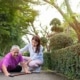 A young woman helping an older woman who has fallen