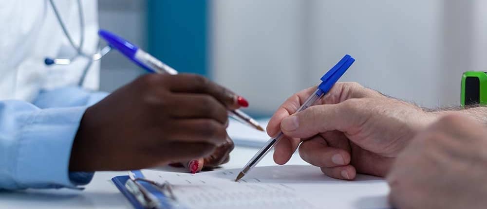 Two clinicians review patient information in the hospital setting