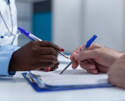 Two clinicians review patient information in the hospital setting