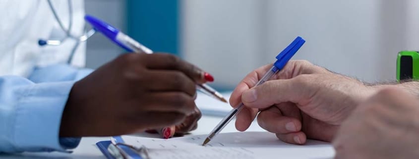 Two clinicians review patient information in the hospital setting