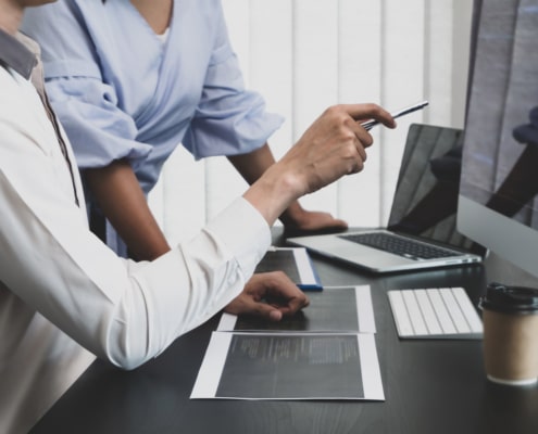 Team of patient safety and quality leaders working with computer