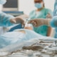 Assistant hands out instruments surgeon during surgery in the operating room