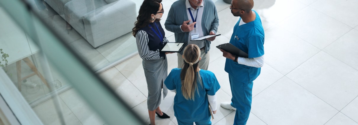 Doctors, medical team and tablet with discussion, advice and above for surgery or patient records.