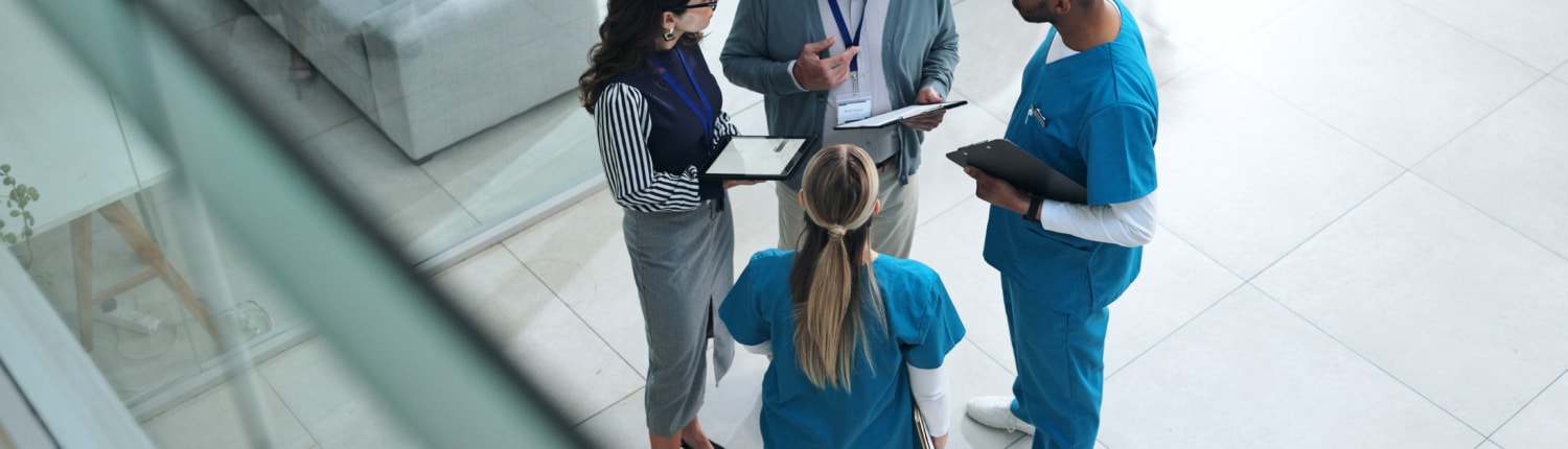Doctors, medical team and tablet with discussion, advice and above for surgery or patient records.