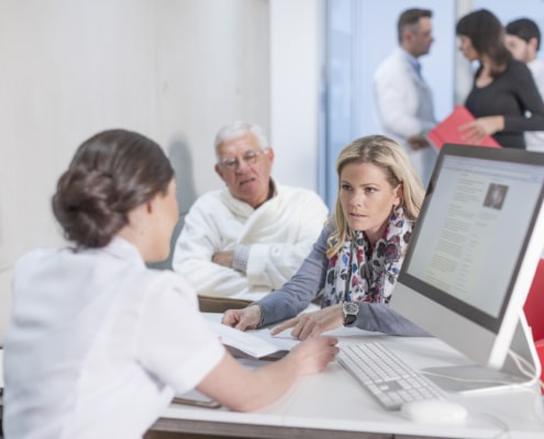 a group of people sitting at a desk