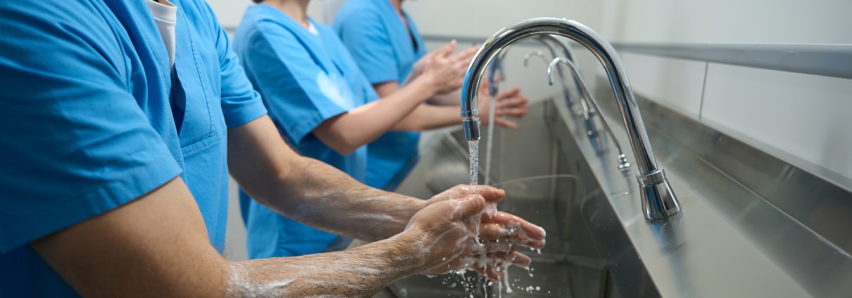 Men and women thoroughly wash their hands
