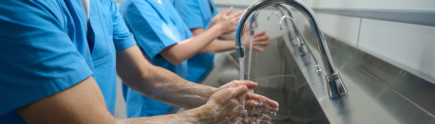 Men and women thoroughly wash their hands