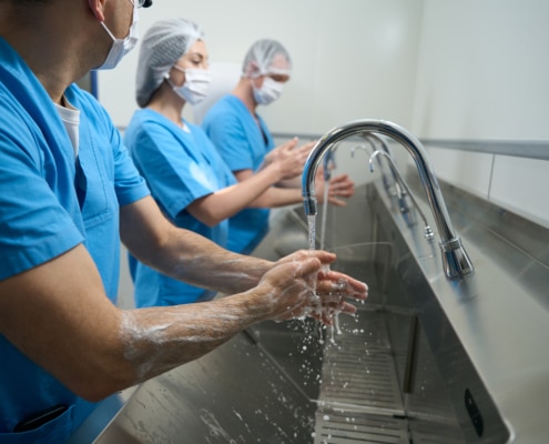 Men and women thoroughly wash their hands